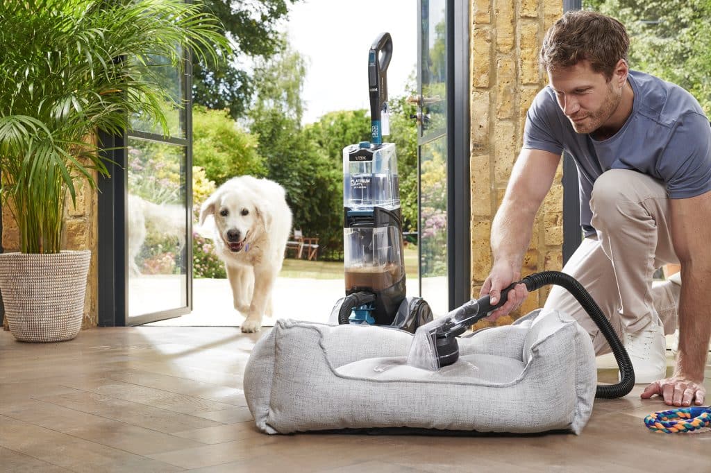 Dad using Vax platinum smart wash cleaning dog bed