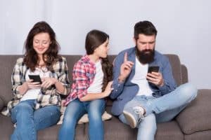  Parents on mobile phones ignoring daughter