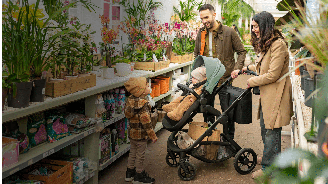 iCandy Orange 4 stroller in a garden centre with parents and 2 children